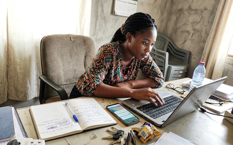 Social media manager replying to customer comments on a laptop