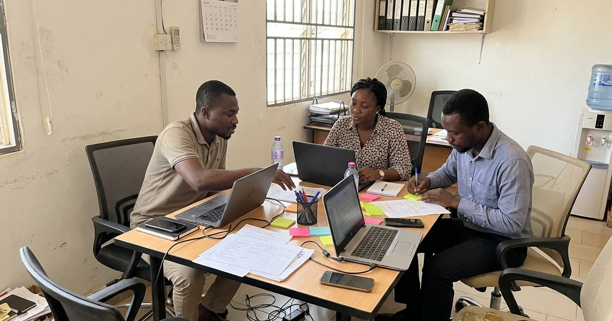 Whizzy Digital team planning a client growth plan around a table in Kumasi
