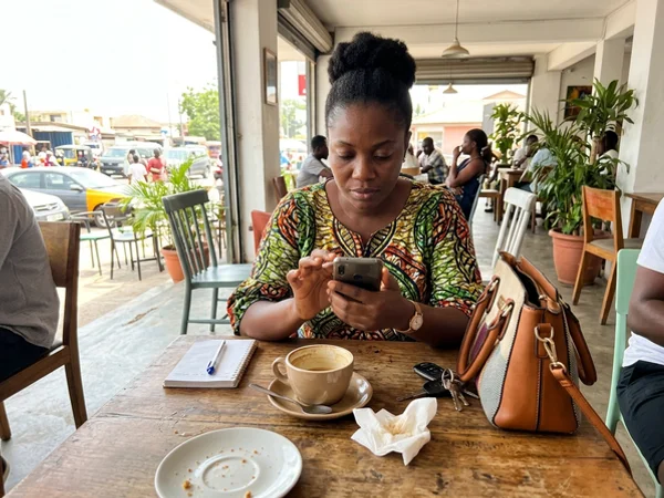 Business owner approving a scheduled post on her phone