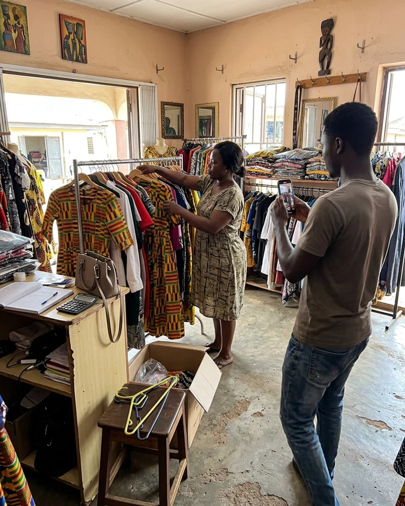 Content creator filming a short video in a Kumasi boutique