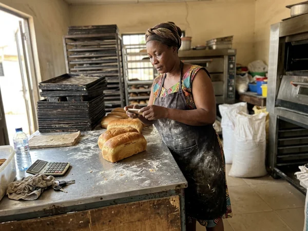 Bakery owner photographing products for her website
