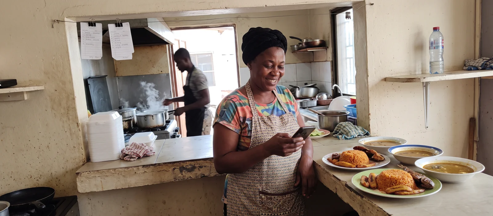 Shop owner in Kumasi serving a customer who found the business on Google Maps