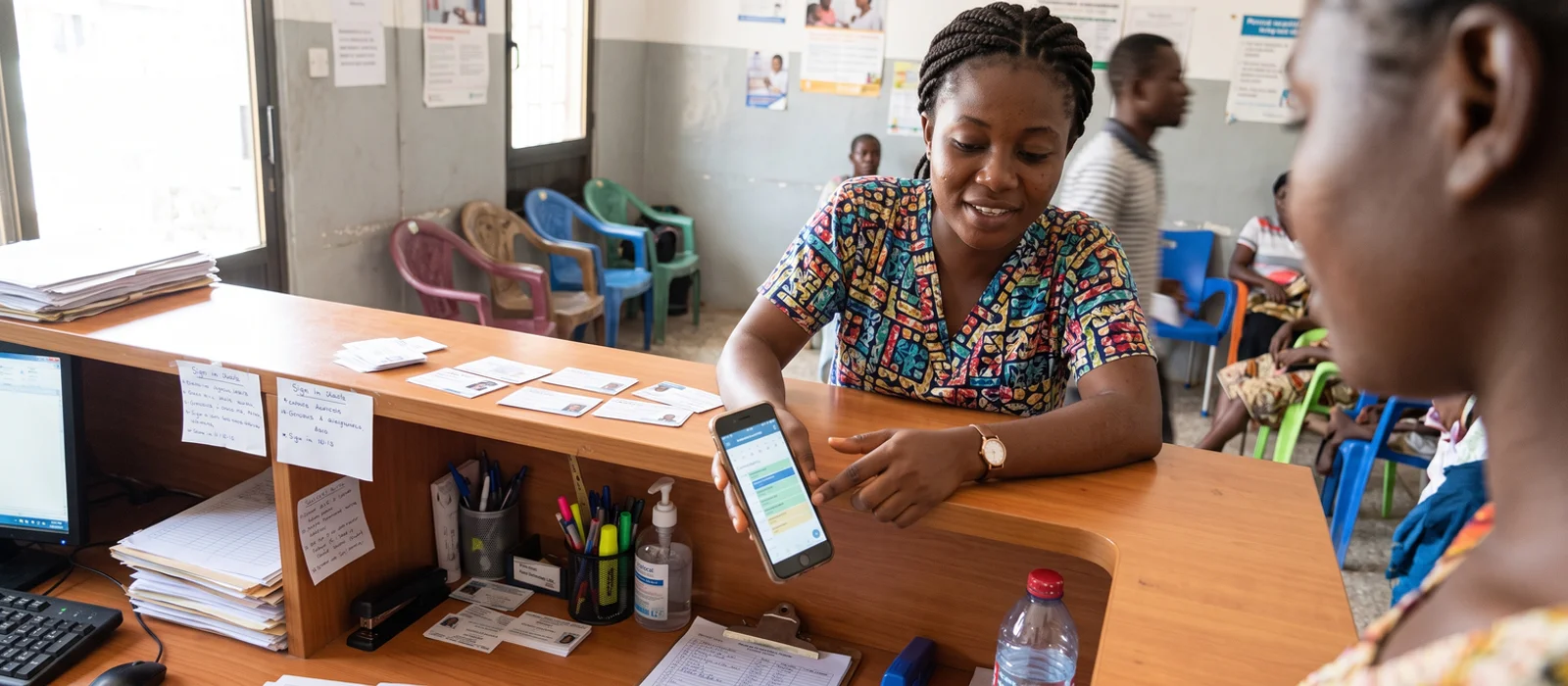Shop owner in Kumasi serving a customer who found the business on Google Maps