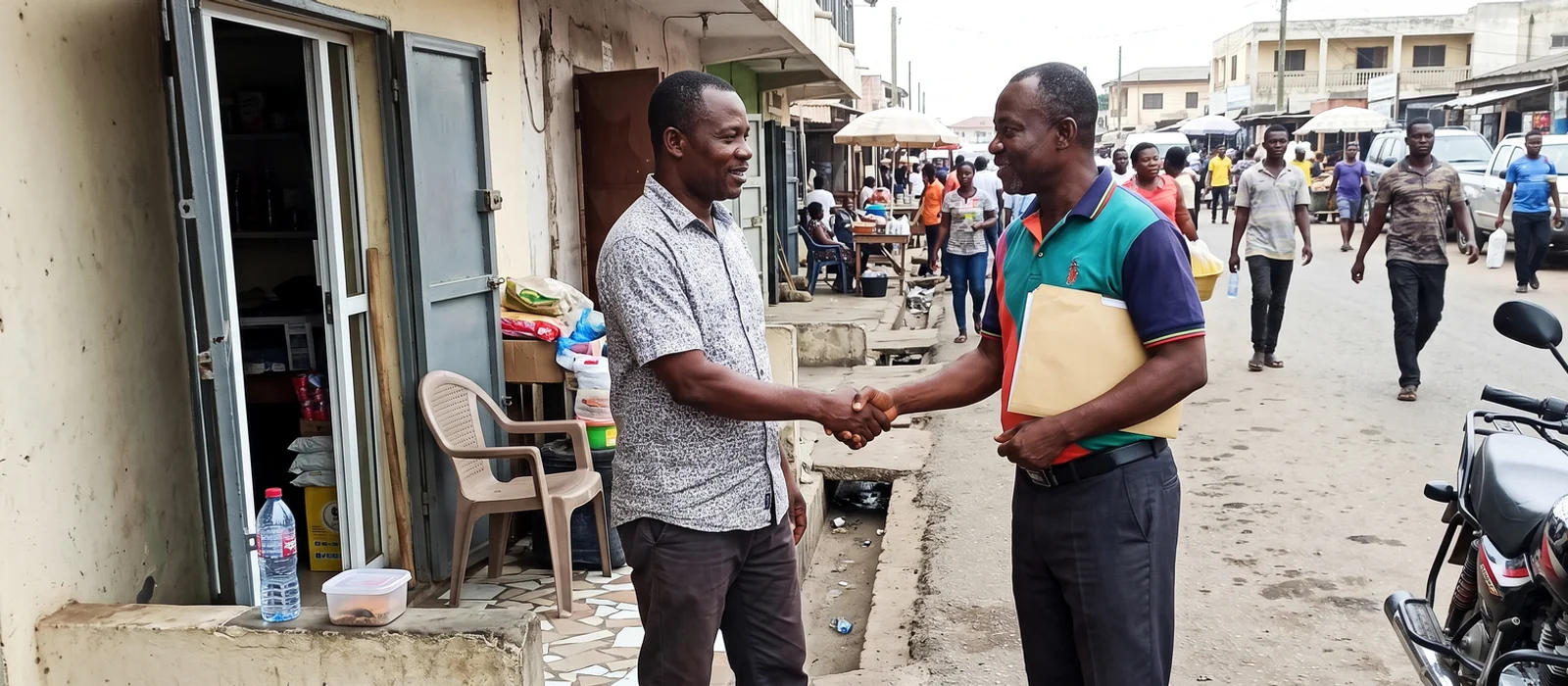 Two business owners shaking hands outside a small shop